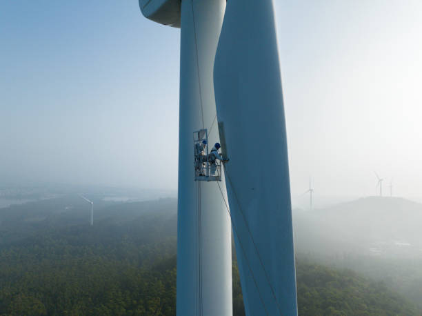 Electrical worker repairing wind turbine blades
