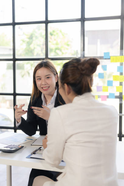 istock Two women talk, discuss, work on new project ideas. Analyze marketing plans and business investments to ensure success. 2180123112