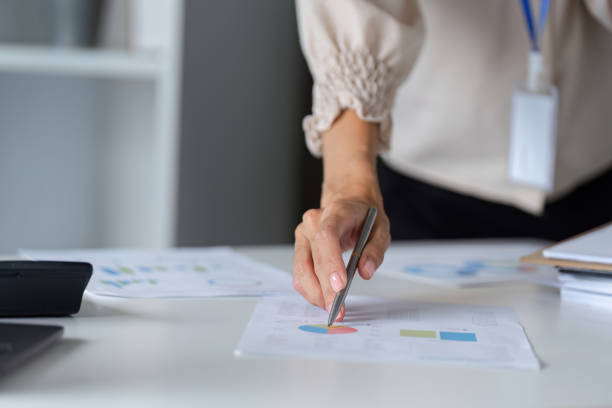 istock Businesswoman Analyzing Financial Documents in Modern Office Setting for Strategic Planning and Decision Making 2180127864