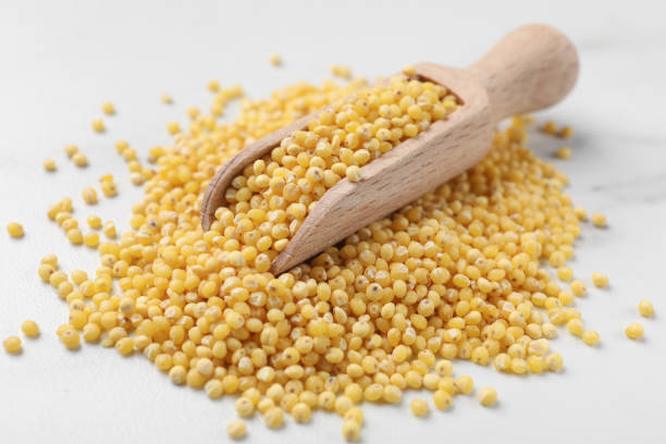 istock Scoop with millet groats on white table, closeup 2180128646