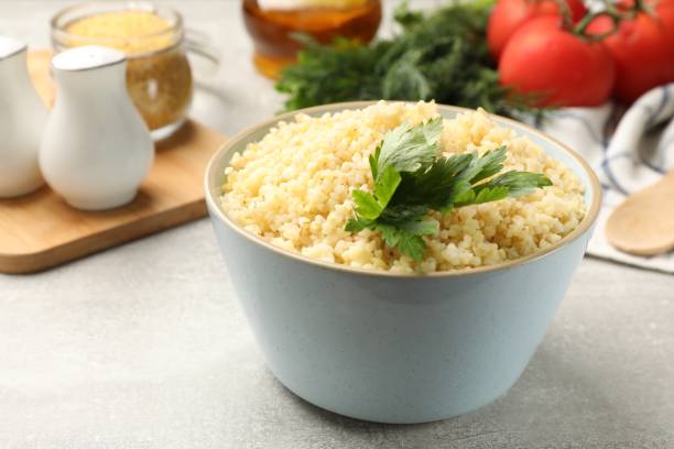 istock Delicious bulgur with parsley on light grey table, closeup 2180128732