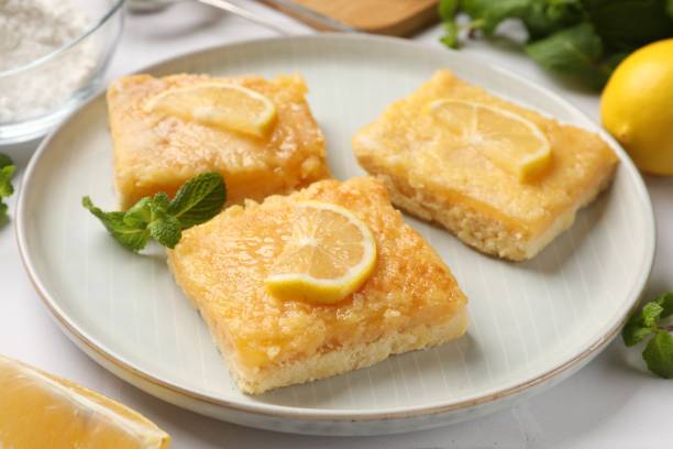 istock Tasty lemon bars and mint on table, closeup 2180130027