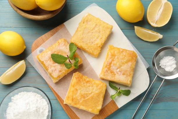 istock Tasty lemon bars and mint on light blue wooden table, flat lay 2180130057