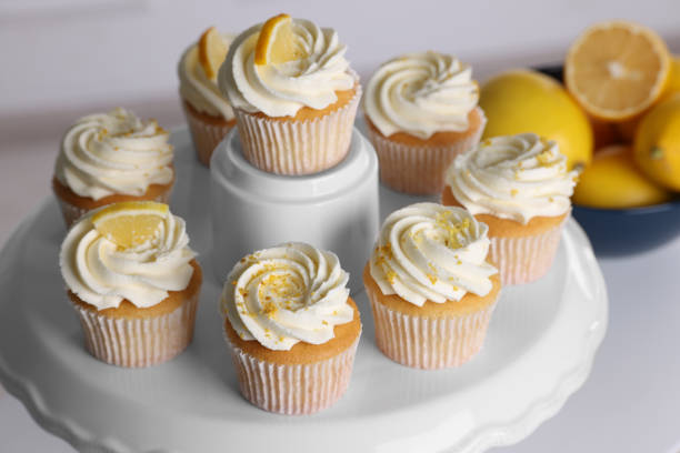 istock Delicious lemon cupcakes with white cream on table, closeup 2180130094