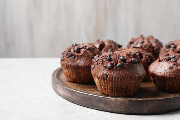 istock Tasty chocolate muffins on grey table, closeup. Space for text 2180130200