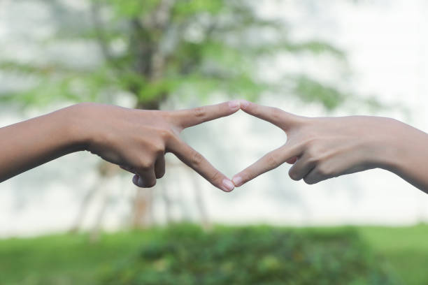 A woman's hand is asking to hold the woman's hand. The two hands are joined together to form a picture frame.