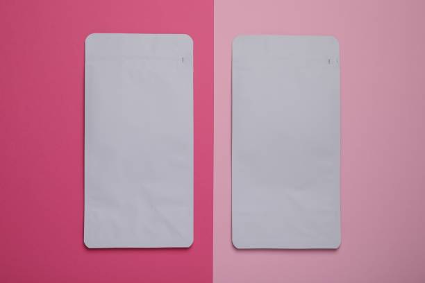 istock Two white bags on pink background, flat lay. Space for text 2180133323