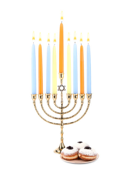 Hanukkah celebration. Menorah with candles and donuts isolated on white