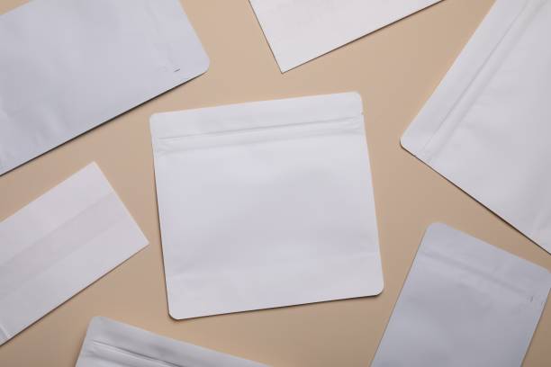 istock White bags on beige background, flat lay. Space for text 2180133372