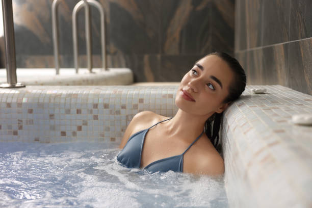 istock Beautiful woman relaxing in spa swimming pool, space for text 2180136643