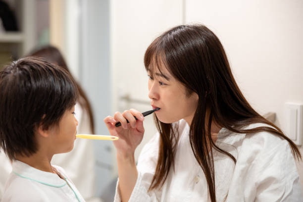 istock Family brushing teeth in hotel room 2180141253