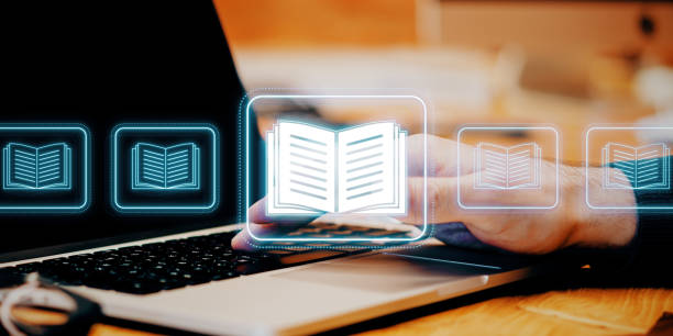 istock Digital library interface with ebook icons floating over a laptop keyboard. 2180150696
