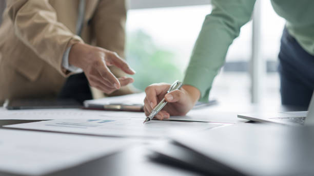 istock Alternative energy environment businesspeople checking document and discuss about renewable energy 2180152493
