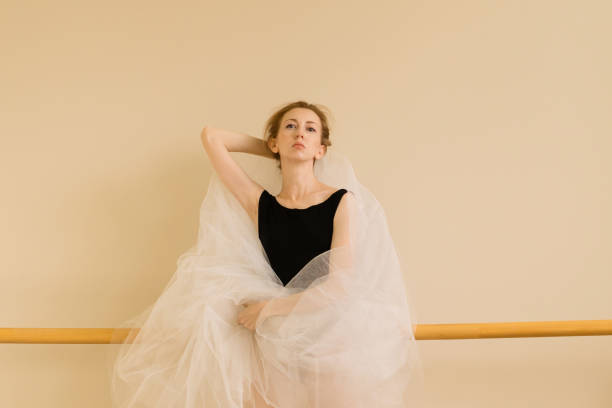istock Ballet dancer poses with tulle fabric in serene studio setting 2180153357