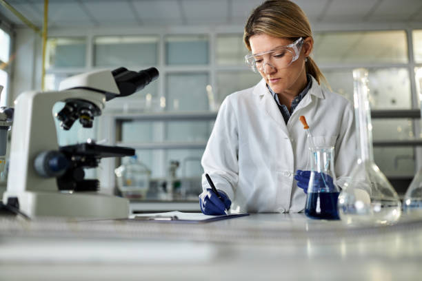 istock Female scientist writing medical test results in laboratory. 2180157308