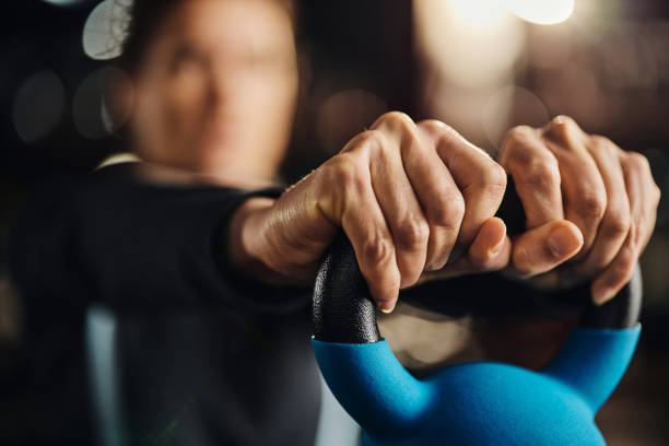 istock Exercising with kettle bell in a gym! 2180158360