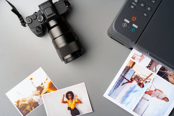 istock Printer and photo camera on table. Printing photos concept 2180160723