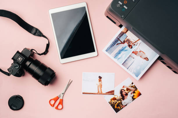 istock Printer, photo camera and digital tablet on table. Printing photos concept 2180160831