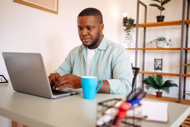 istock Young adult spending time at home studying using laptop 2180163055
