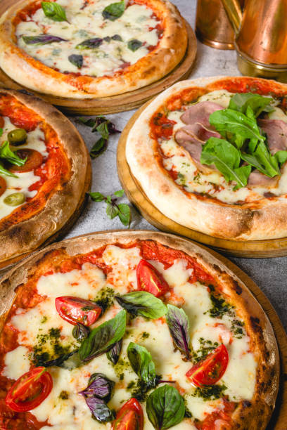 istock Top view of various neapolitan pizzas on grey stone table 2180165835