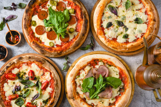 istock Top view of various neapolitan pizzas on grey stone table 2180165864