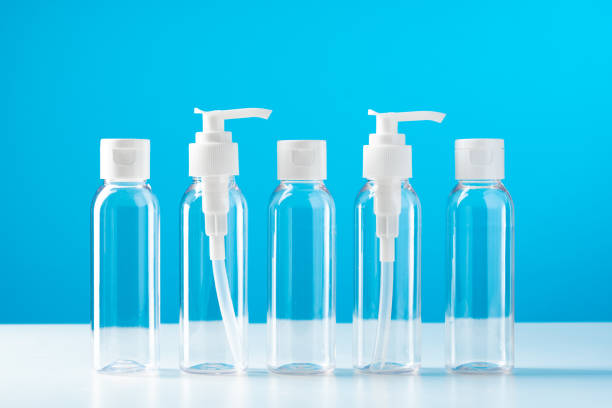 istock Clear plastic bottles with pumps arranged on a table against a bright blue background 2180165895