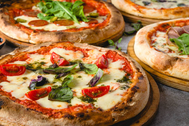 istock Top view of various neapolitan pizzas on grey stone table 2180166212