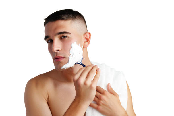 istock Young handsome man applying shaving foam against white background 2180167745