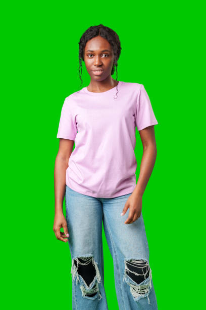 istock A joyful young woman smiling brightly while standing against a vivid green background 2180169882