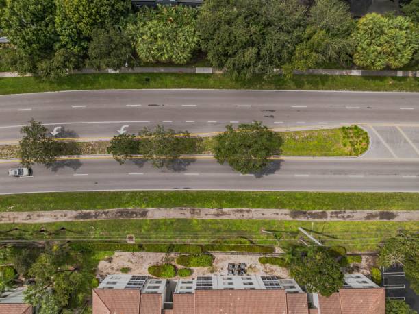 istock Aerial suburban road with greenery and car. 2180172087