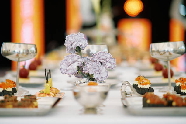 Elegant banquet table set for a formal dining experience featuring gourmet appetizers and floral centerpiece