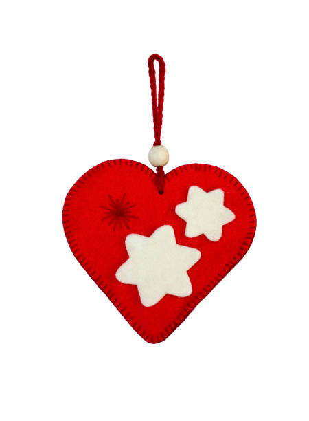 hand made wooden heart, with inlays and marquetry, hanging at a window with metal security grate and mosquito net