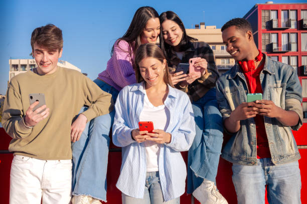 istock Students having fun with mobile phones creating content on social media. 2180179346