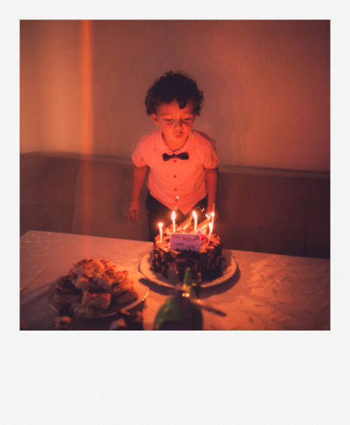 istock Happy Birthday Boy Blowing Out Candles 2180182089