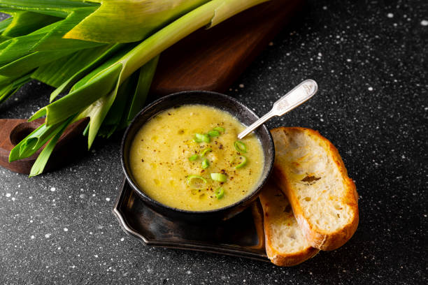 A bowl of leek soup with toasted bread