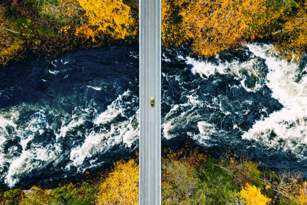 istock Aerial view of fall forest and blue river with bridge in Finland. 2180187501