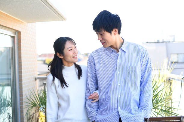 istock Smiling Asian couple (lovers) talking outdoors 2180189279