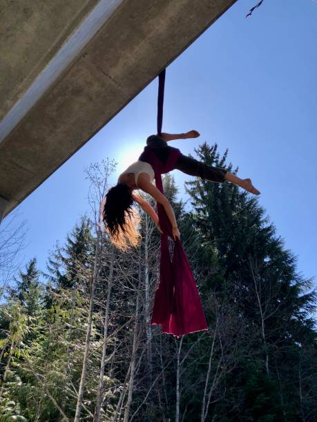 Young woman performs aerial silks