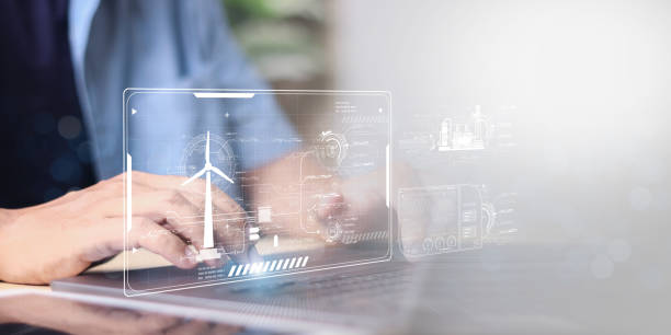istock Businessman using laptop with Alternative energy for the future concept,Wind turbines change wind energy into electrical energy. 2180191141