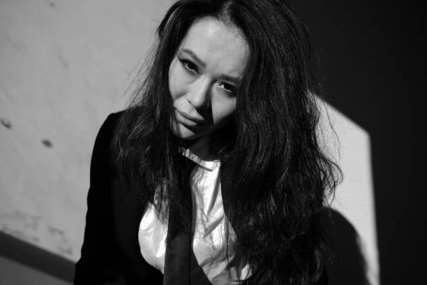 A portrait of a beautiful young woman wearing a suit.