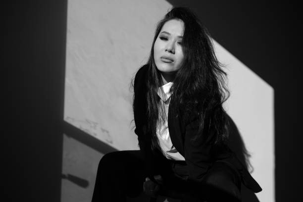 A portrait of a beautiful young woman wearing a suit.