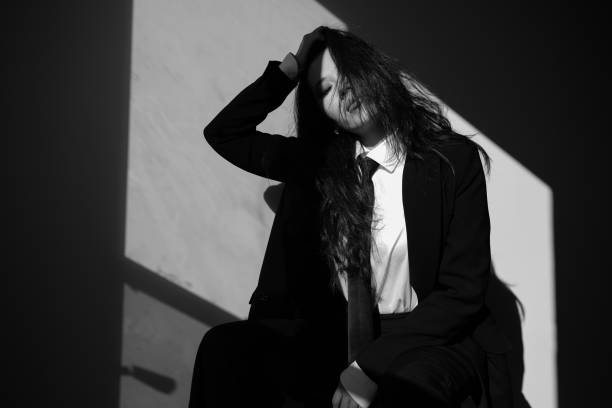 A portrait of a beautiful young woman wearing a suit.