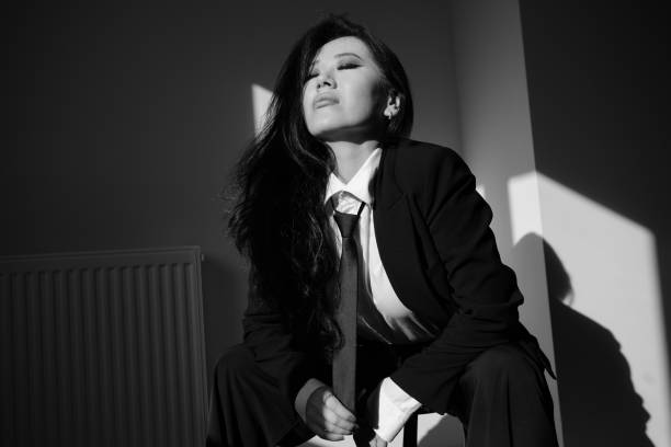 A portrait of a beautiful young woman wearing a suit.