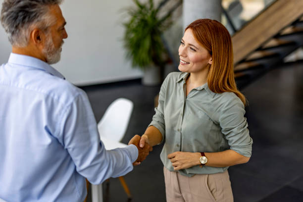istock Professional Business Handshake Between Two Colleagues in Office Setting 2180193538