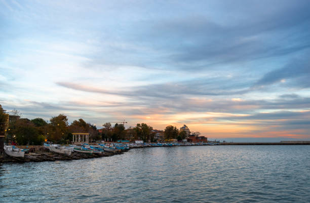 Fishing boats on the shore in Pomorie town at sunset. Bulgaria, Eastern Europe.