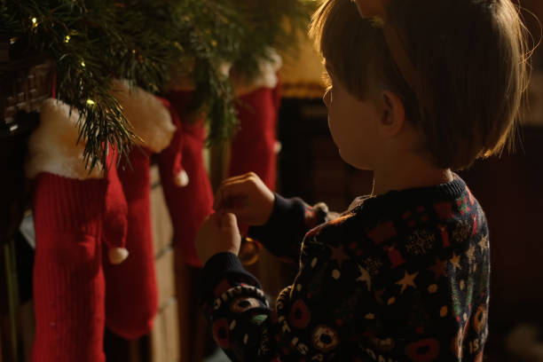 istock Small child decorates cozy house with Christmas baubles. 2180195336