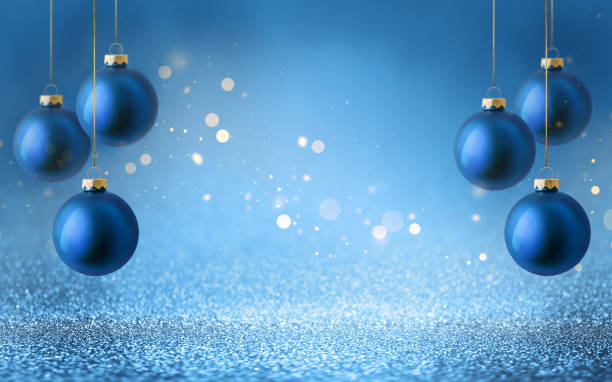 istock Christmas tree baubles on shiny glitter blue background with bokeh light. Festive winter holiday decoration and ornament. 2180195497