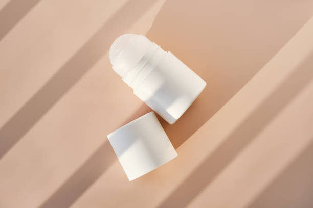 Roll-on deodorant on a purple background with shadow stripes.