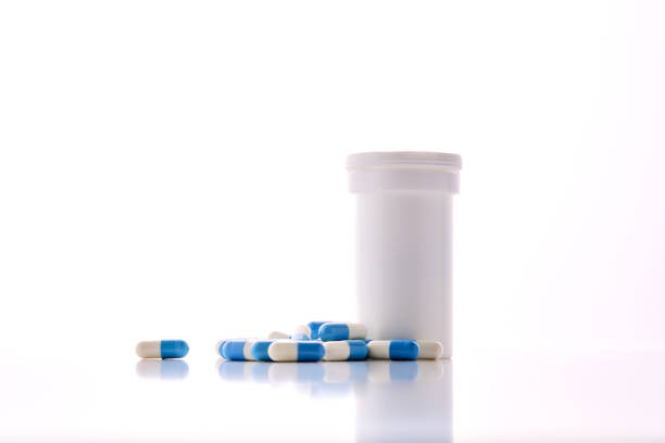 istock Bottle with white and blue capsules on a white background. 2180196309