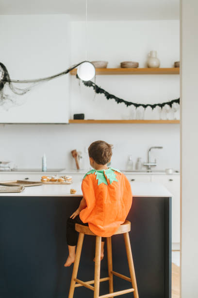 istock Boy wearing pumkin costume 2180196536